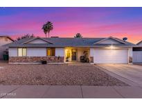 Charming single-story home featuring desert landscaping, stone accents, and attached two-car garage at 6237 E Inglewood St, Mesa, AZ 85205