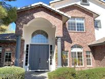 Inviting front entrance with a brick facade, arched doorway, and well-maintained landscaping at 6834 E Culver St, Mesa, AZ 85207