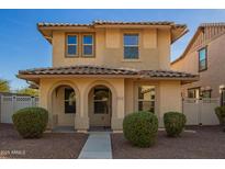 Charming two-story home featuring a tiled roof, arched porch entry, and well-maintained landscaping at 919 S Pheasant Dr, Gilbert, AZ 85296