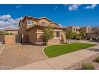 Charming two-story home with landscaped yard and inviting curb appeal under a sunny blue sky at 18436 E Celtic Manor Dr, Queen Creek, AZ 85142