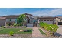 Charming single-story home featuring a well-maintained lawn, brick walkway, and desert landscaping at 18925 W Windsor Blvd, Litchfield Park, AZ 85340
