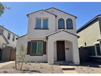 Charming two-story home with a well-manicured yard, inviting entrance and an arched entryway at 1909 W Lariat Ln, Phoenix, AZ 85085