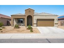 Charming single-story home with a two-car garage and well-maintained xeriscaped front yard at 23830 W Romley W Ave, Buckeye, AZ 85326