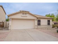 Charming single-story home with a neutral color palette and a two-car garage at 2439 W White Feather Ln, Phoenix, AZ 85085