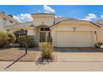 Charming single-story home featuring low-maintenance landscaping, two-car garage and neutral-toned stucco at 3357 W Barcelona Dr, Chandler, AZ 85226