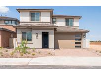 Two-story home featuring neutral stucco, two-car garage, tile roof and low maintenance landscaping at 40250 N Alegre Dr, San Tan Valley, AZ 85140