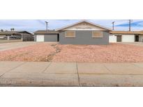 Charming home with gray brick exterior and low maintenance rock front yard at 5208 W Earll Dr, Phoenix, AZ 85031