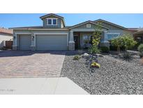 Charming single-story home featuring a two-car garage, desert landscaping, and a welcoming front entrance at 5621 N 189Th Dr, Litchfield Park, AZ 85340