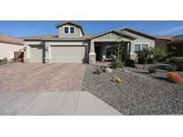 Charming single-story home with a three-car garage, desert landscaping, and inviting curb appeal at 5621 N 189Th Dr, Litchfield Park, AZ 85340