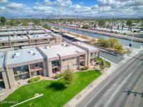 An aerial view of the condo complex, showing the landscaping, canal, and parking areas at 7436 E Chaparral Rd # B103, Scottsdale, AZ 85250