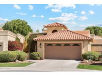 Charming home featuring a terracotta tile roof and a spacious two-car garage at 9445 N 106Th St, Scottsdale, AZ 85258