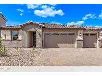 Charming single-story home showcasing a paver driveway and a neutral color palette against a vibrant blue sky at 12378 W Marguerite Ave, Avondale, AZ 85323