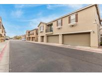 Street view of townhomes with two-car garages and neutral colored stucco at 1265 S Aaron -- # 355, Mesa, AZ 85209