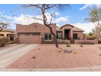 Single level home with two-car garage and desert landscaping provides great curb appeal at 1312 N Joplin Cir, Mesa, AZ 85207