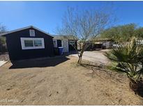 Charming single-story home featuring a xeriscaped front yard with desert-friendly landscaping at 2205 W Hadley St, Phoenix, AZ 85009