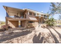 A charming two-story home featuring a spacious balcony and unique architectural details at 27002 N 64Th St, Scottsdale, AZ 85266