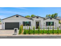 Charming single-story home with white brick, black trim, manicured lawn, and tasteful landscaping at 4115 E Windsor Ave, Phoenix, AZ 85008