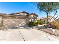 Inviting single-story home featuring a two-car garage, desert landscaping, and a terracotta-tiled roof at 4674 E Alfalfa Dr, Gilbert, AZ 85298