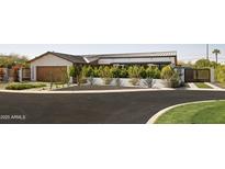 Beautiful exterior view with manicured landscaping, a well-maintained lawn, and a gated driveway at 5812 N 44Th Pl, Phoenix, AZ 85018