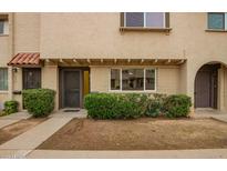 Charming townhouse with a well-maintained lawn and inviting front entrance at 6841 E Osborn Rd # C, Scottsdale, AZ 85251