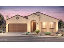 Charming single-story home with a two-car garage, stucco siding, and a beautifully landscaped front yard at 7681 W Meadowlark Way, Florence, AZ 85132