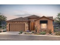Charming single-story home featuring a stone facade, tile roof, two-car garage, and professionally landscaped yard at 7723 W Cactus Wren Way, Florence, AZ 85132