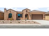 Charming single-story home featuring desert landscaping, a tile roof, and a welcoming front entrance at 7836 W Mockingbird Way, Florence, AZ 85132