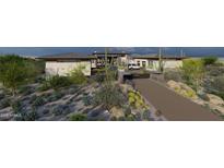 A modern home featuring desert landscaping, a private driveway, and a stylish exterior design at 8395 E Leaning Rock Rd # 187, Scottsdale, AZ 85266