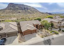 Beautiful single-story home featuring desert landscaping and a tile roof with mountain views at 10672 N 140Th Way, Scottsdale, AZ 85259