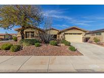 Charming single-story home featuring a well-manicured front yard and a two-car garage at 12320 W Lone Tree Trl, Peoria, AZ 85383