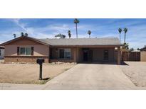 Charming single-story home featuring a covered carport, low maintenance landscaping, and neutral exterior paint at 12402 N 36Th Dr, Phoenix, AZ 85029