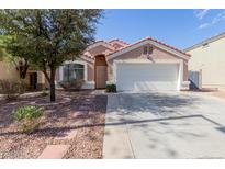 Charming single-story home featuring a well-maintained front yard, two-car garage, and a terracotta-tiled roof at 1422 S 231St Ln, Buckeye, AZ 85326