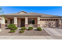 Charming single-story home with a well-maintained front yard and a two car garage at 17574 W Corrine Dr, Surprise, AZ 85388