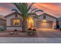 Charming single-story home with a well-manicured front yard and a brick-paved driveway and two car garage at 18259 W Buena Vista Dr, Surprise, AZ 85374