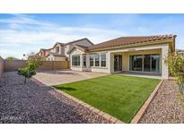 Backyard featuring a covered patio, a low-maintenance artificial lawn, and gravel landscaping at 1855 E Crescent Way, Chandler, AZ 85249