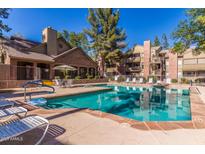 Enjoy the community pool with lounge chairs and umbrella covered tables perfect for relaxing on hot summer days at 200 E Southern Ave # 173, Tempe, AZ 85282