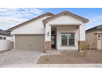 Beautiful single-story home featuring a two car garage, covered porch, and stone accents at 20318 W Turney Ave, Buckeye, AZ 85396