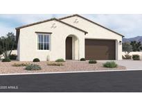 Charming single-story home with desert landscaping, a arched front door, and a two car garage at 2401 E Spur Dr, San Tan Valley, AZ 85140