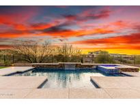 Sparkling pool with spa, surrounded by desert landscape and breathtaking sunset views at 30804 N 120Th Ave, Peoria, AZ 85383