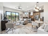 Bright open-concept living room with modern furnishings, marble floors, and a seamless indoor-outdoor flow at 377 E Windsor Ave # 19, Phoenix, AZ 85004