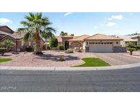 Attractive single-story home with a desert landscape and a three-car garage at 4068 N 155Th Ln, Goodyear, AZ 85395