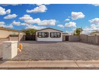 Charming home featuring gravel landscaping, modern shutters, and a spacious parking area at 525 S 99Th St, Mesa, AZ 85208