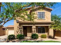 Inviting two-story home featuring desert landscaping, neutral colors, and an attached two-car garage at 560 E Rainbow Dr, Chandler, AZ 85249