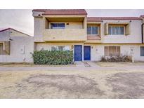 Multi-level townhome showcasing a red tile roof, stucco exterior, and a well-maintained front yard space at 6333 N 49Th Ave, Glendale, AZ 85301