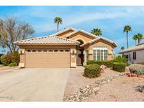 Charming single-story home featuring a tile roof, well-manicured landscaping, and a two-car garage at 7118 E Juanita Ave, Mesa, AZ 85209