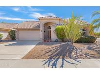 Charming home featuring a well-manicured front yard with desert landscaping, providing curb appeal at 9039 W Wescott Dr, Peoria, AZ 85382