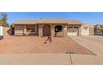 Charming single-story home with desert landscaping, and inviting covered porch at 1022 W Watson Dr, Tempe, AZ 85283