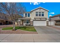 Charming two-story home featuring stone accents, a well-manicured lawn, and a welcoming front porch at 1928 E 39Th Ave, Apache Junction, AZ 85119