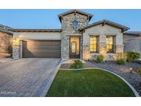 Charming single-Gathering home with manicured lawn, stone accents, and a two-car garage at 2113 N Trowbridge St, Mesa, AZ 85207