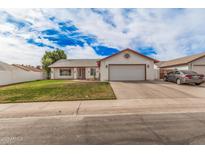 Charming single-story home with a two-car garage and well-manicured front yard at 2327 W Rockwell Ct, Chandler, AZ 85224